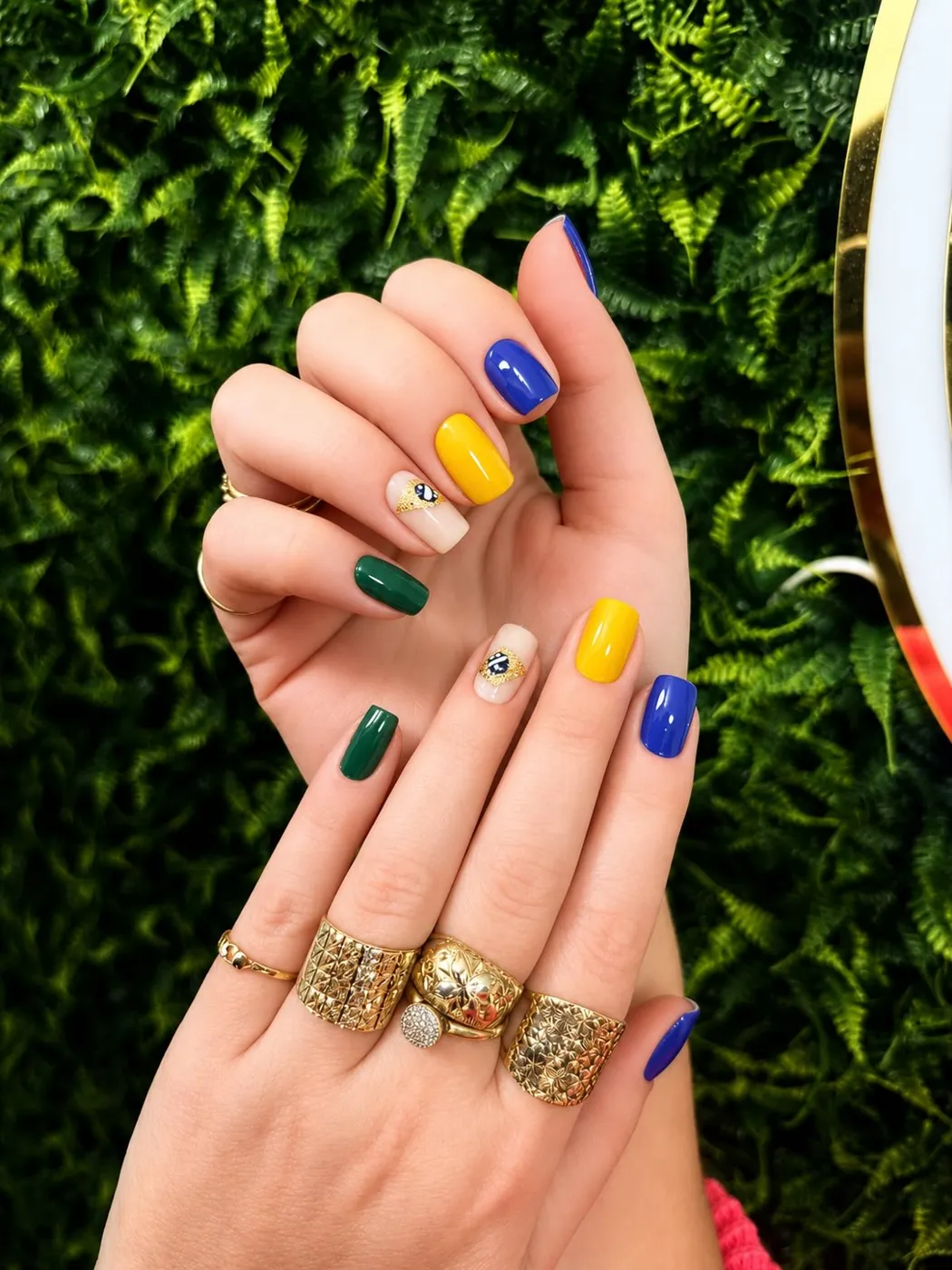 Unhas coloridas em verde, amarelo e azul